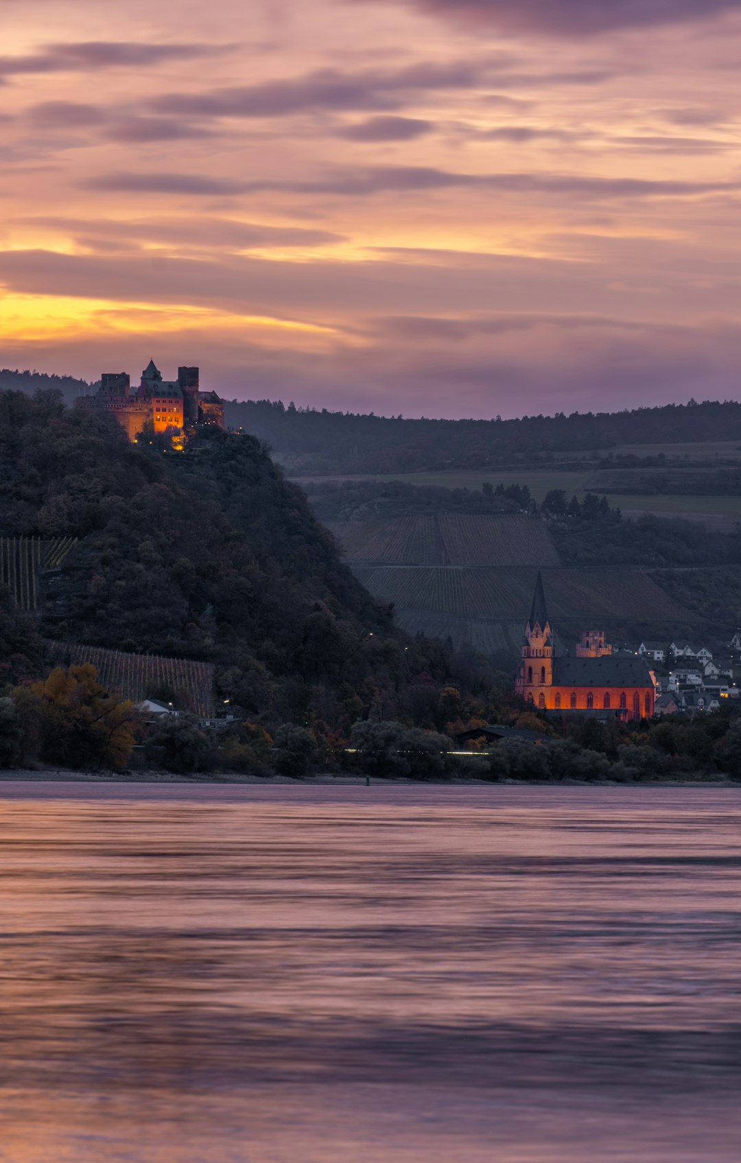 a castle on a hill overlooking a body of water